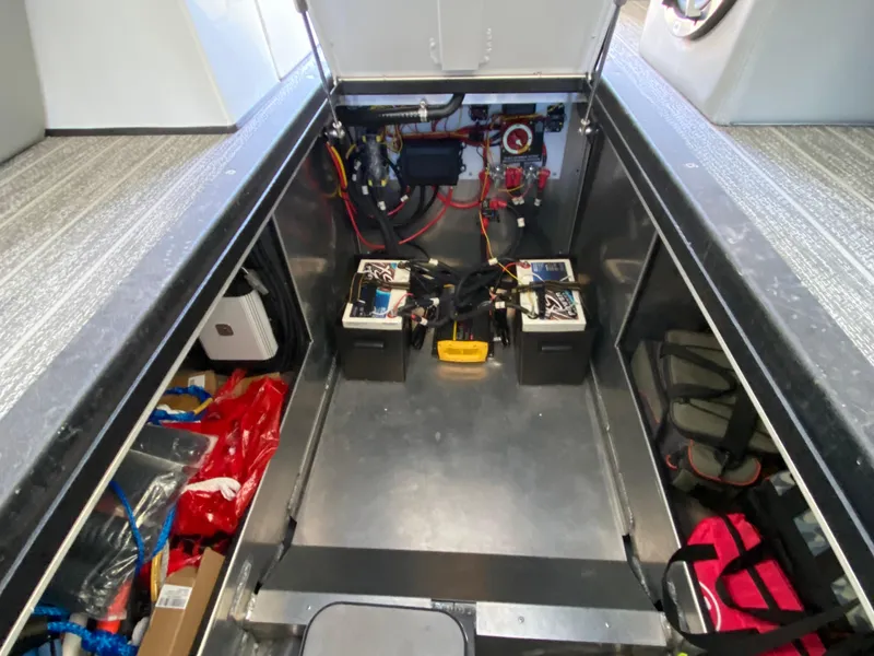 Slide: The Image of 2022 Montara 25 SURF BOSS 2.0 engine compartment with batteries and wiring. - 16