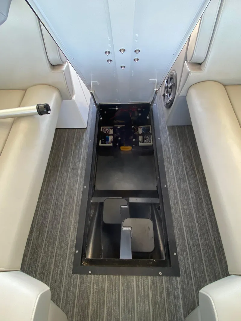 Slide: The Image of 2022 Montara 25 SURF BOSS 2.0 interior with storage compartment and seating. - 17