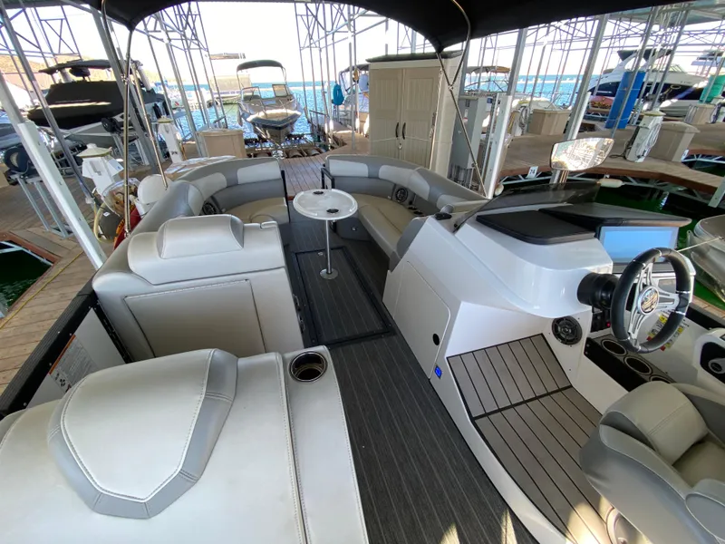 Slide: The Image of 2022 Montara 25 SURF BOSS 2.0 boat interior with seating and helm. - 3