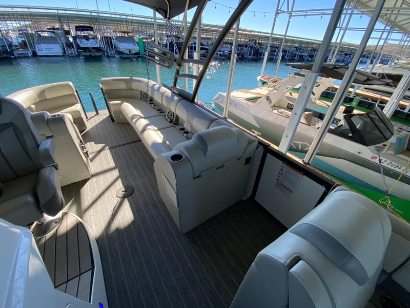 Slide: The Image of 2022 Montara 25 SURF BOSS 2.0 boat interior with spacious seating at marina. - 4