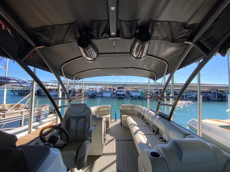 Slide: The Image of 2022 Montara 25 SURF BOSS 2.0 boat interior with seating and steering wheel. - 5