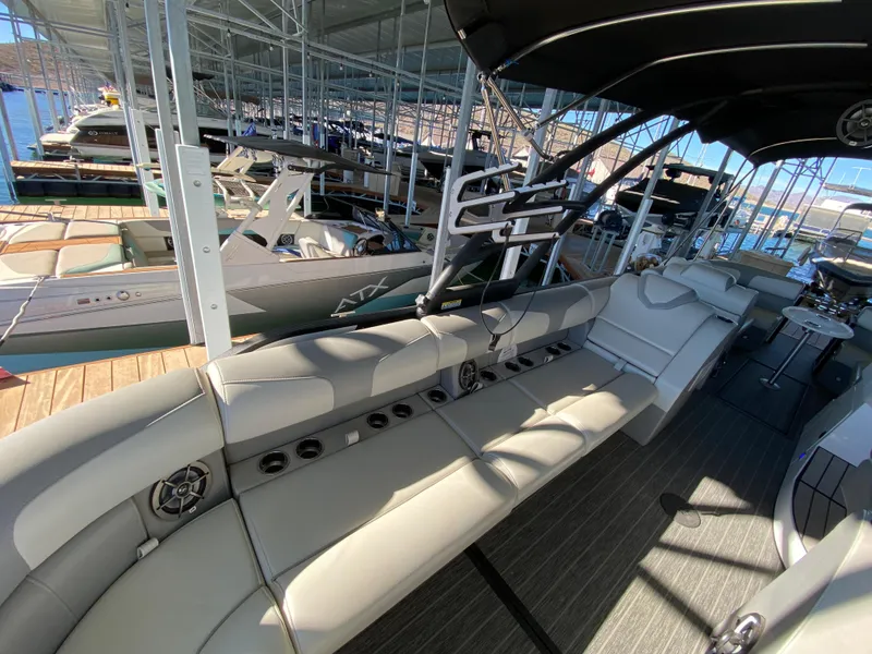 Slide: The Image of 2022 Montara 25 SURF BOSS 2.0 boat interior with spacious seating at marina. - 6