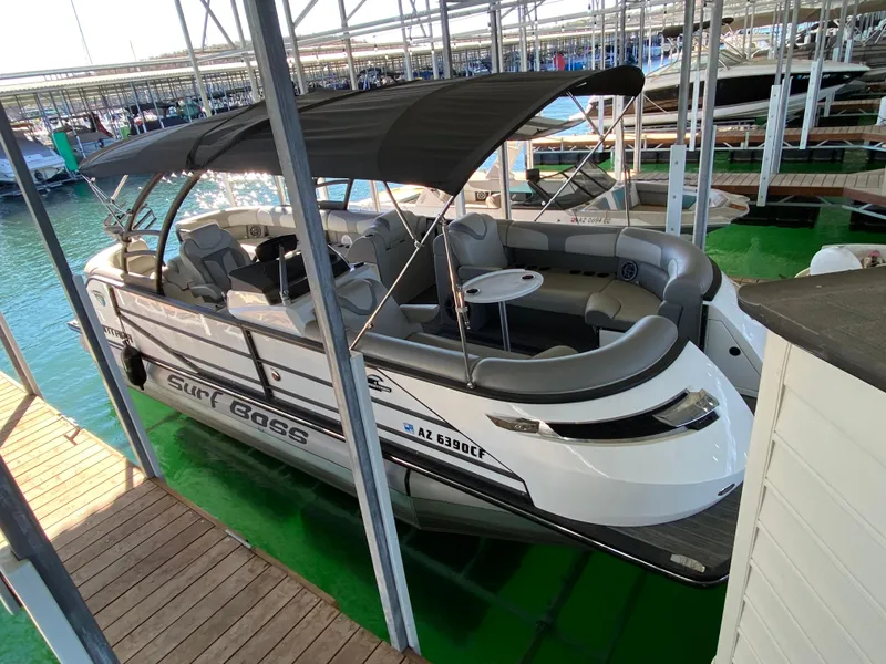 Slide: The Image of 2022 Montara 25 SURF BOSS 2.0 boat docked, featuring spacious seating and canopy. - 8