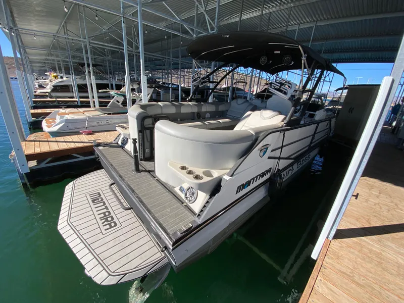 Slide: The Image of 2022 Montara 25 SURF BOSS 2.0 boat docked in a marina, featuring spacious seating and sleek design. - 9