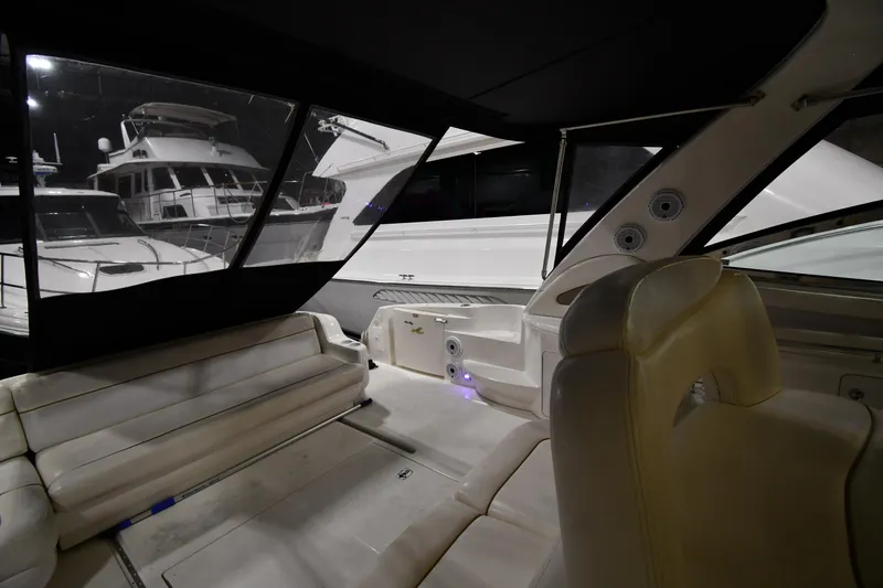 Slide: The Image of Interior view of 2000 Sea Ray 460 Sundancer yacht with white seating and windows. - 12