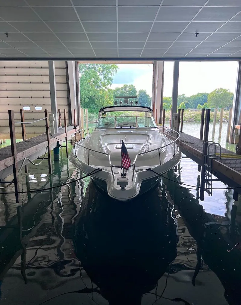 Slide: The Image of 2000 Sea Ray 460 Sundancer yacht docked indoors with American flag. - 2