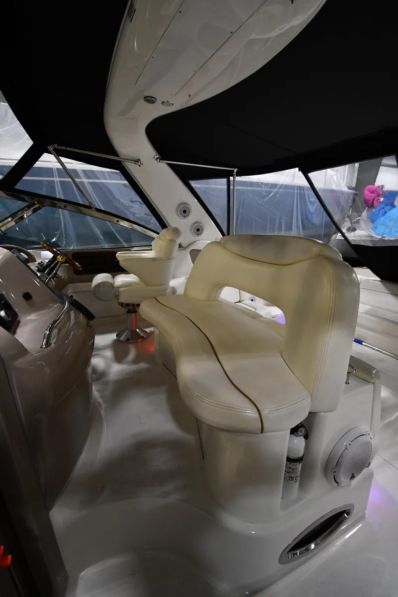 Slide: The Image of 2000 Sea Ray 460 Sundancer interior with white seating and helm station. - 21