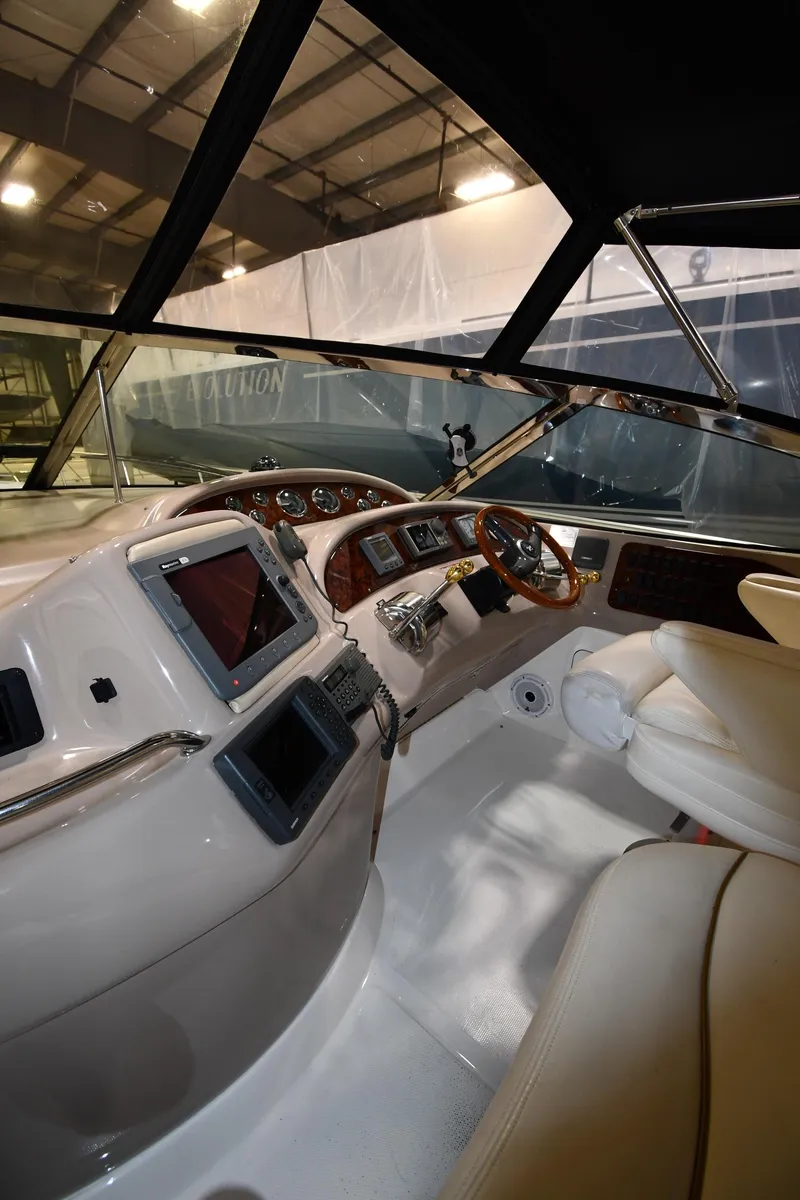 Slide: The Image of Interior view of 2000 Sea Ray 460 Sundancer yacht cockpit with modern controls. - 23