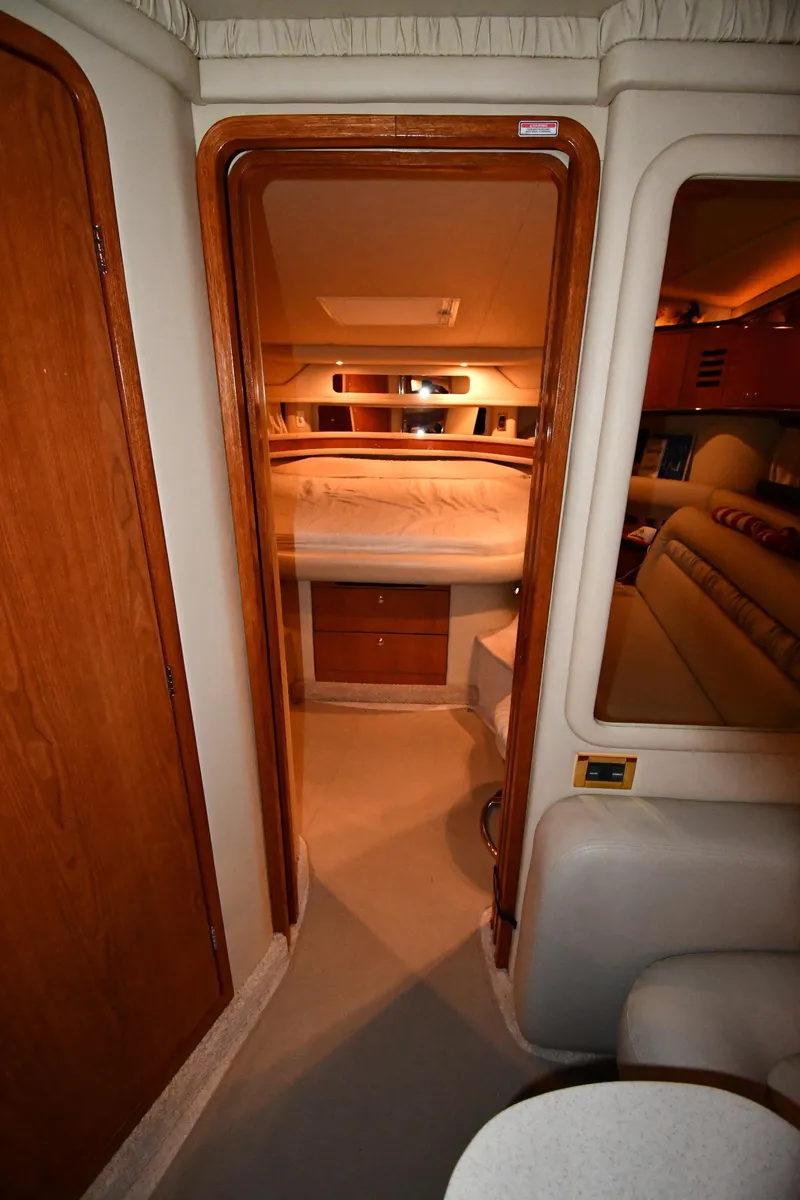 Slide: The Image of Interior view of 2000 Sea Ray 460 Sundancer yacht cabin with bed and seating area. - 26
