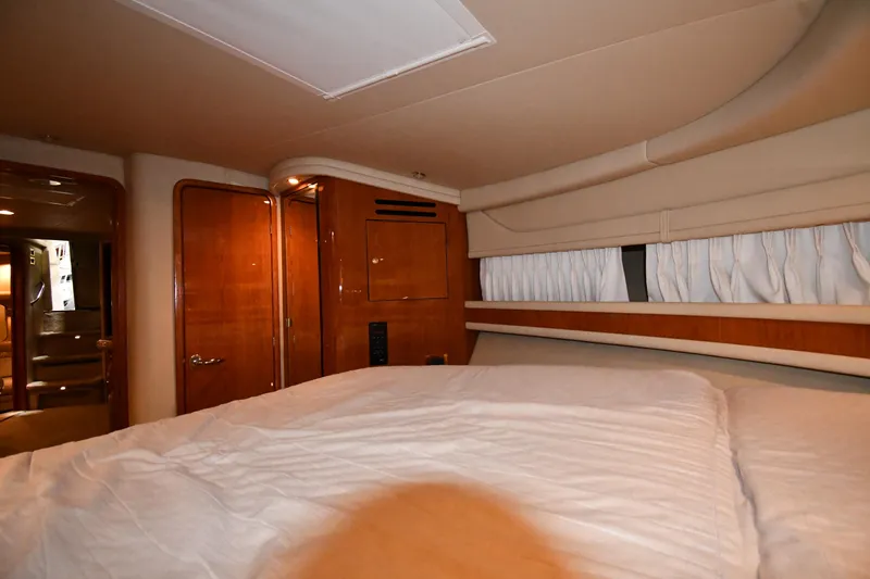 Slide: The Image of Interior cabin of 2000 Sea Ray 460 Sundancer yacht with wood paneling and bed. - 30