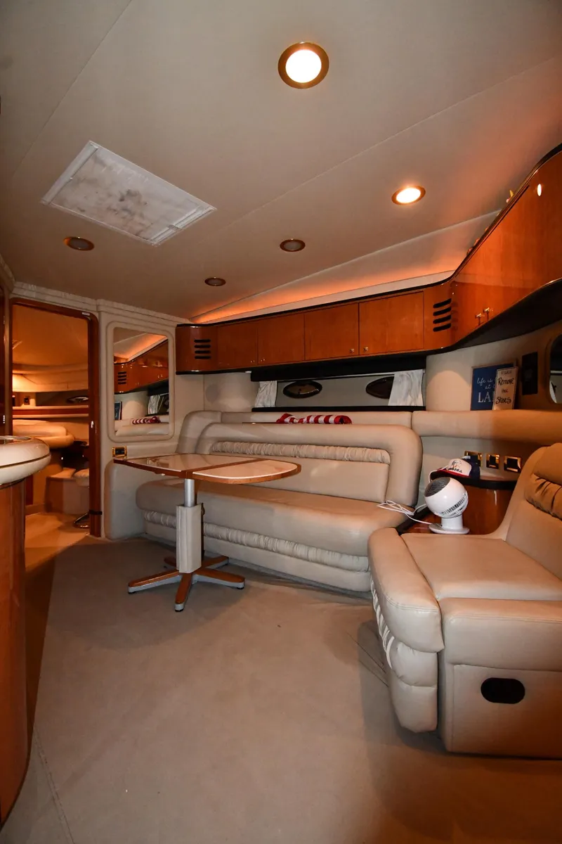 Slide: The Image of Interior of 2000 Sea Ray 460 Sundancer yacht with plush seating and elegant wood finishes. - 37