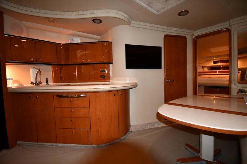 Slide: The Image of Interior of 2000 Sea Ray 460 Sundancer yacht with modern kitchen and dining area. - 38