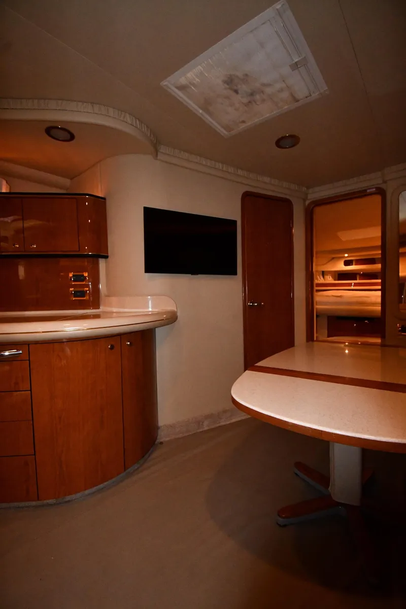 Slide: The Image of Interior of 2000 Sea Ray 460 Sundancer yacht with modern wood cabinetry and dining area. - 39