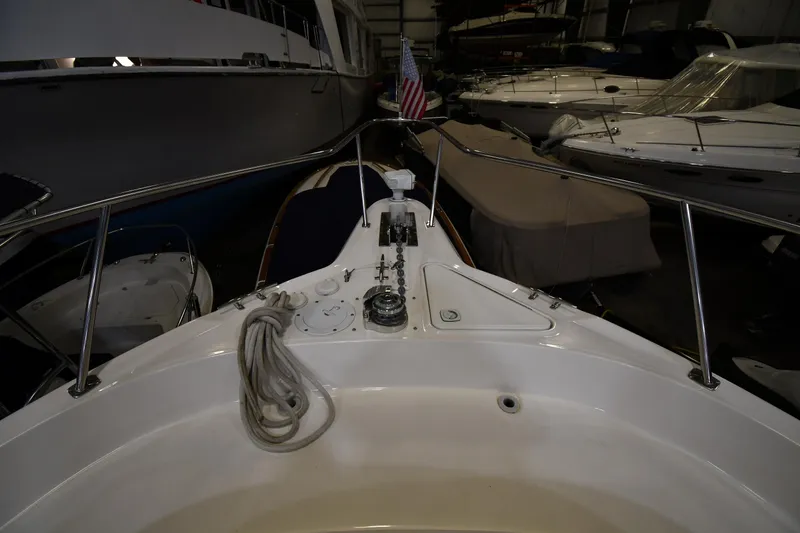Slide: The Image of 2000 Sea Ray 460 Sundancer yacht bow in a dimly lit marina storage. - 4