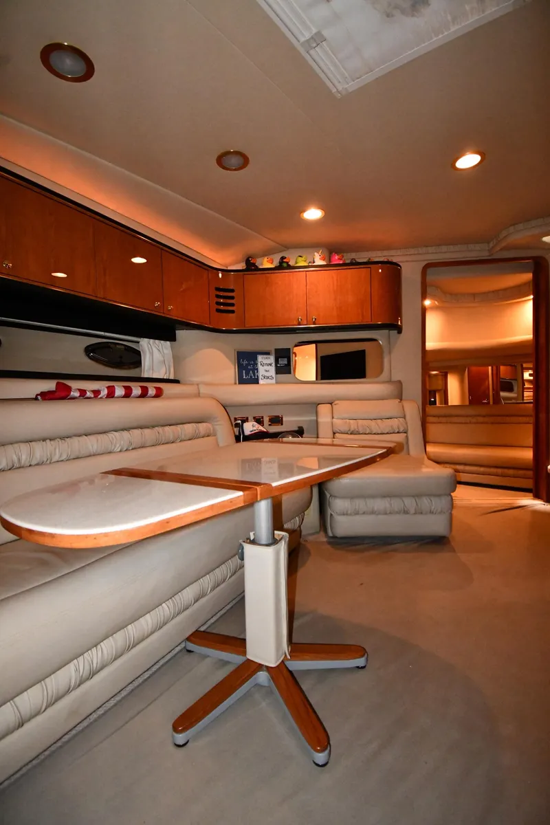 Slide: The Image of Interior of 2000 Sea Ray 460 Sundancer yacht with elegant seating and wooden table. - 44