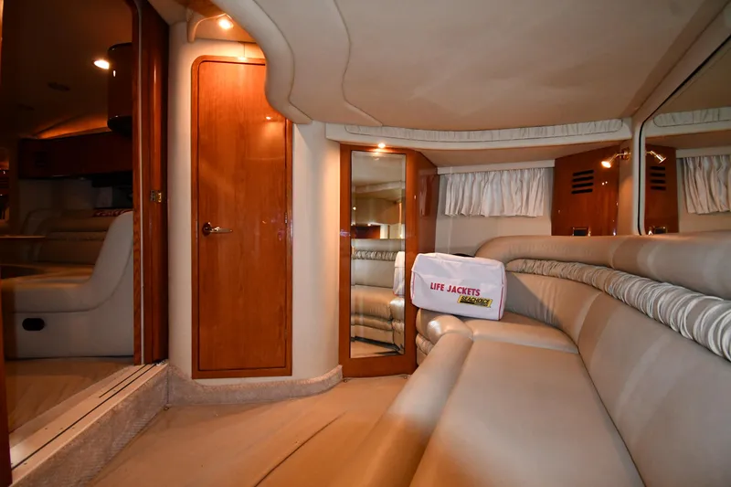 Slide: The Image of Interior of 2000 Sea Ray 460 Sundancer yacht with plush seating and wooden accents. - 50