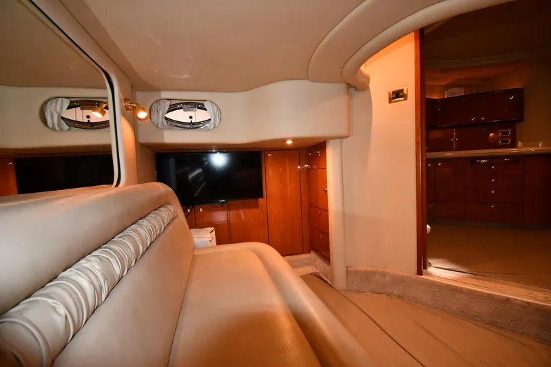 Slide: The Image of Interior of 2000 Sea Ray 460 Sundancer yacht with beige seating and wooden cabinetry. - 52
