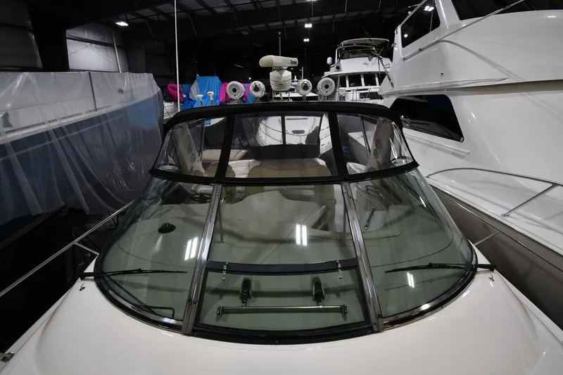 Slide: The Image of 2000 Sea Ray 460 Sundancer yacht in storage, showcasing sleek design and spacious cockpit. - 7
