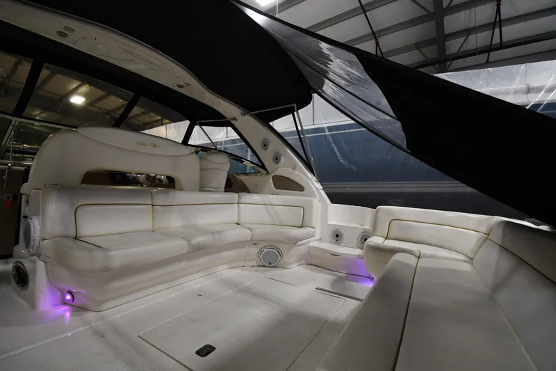Slide: The Image of 2000 Sea Ray 460 Sundancer interior with white seating and ambient lighting. - 8