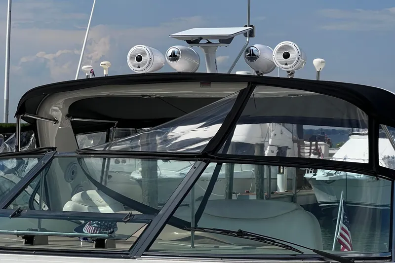 Slide: The Image of 2000 Sea Ray 460 Sundancer yacht with speakers and radar, docked at marina. - 83