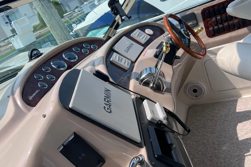 Slide: The Image of Helm of 2000 Sea Ray 460 Sundancer with Garmin navigation system and wood-trimmed steering wheel. - 86