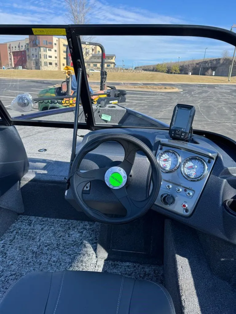 Slide: The Image of 2025 Tracker Pro Guide V-16 WT boat interior with steering wheel and dashboard controls. - 7