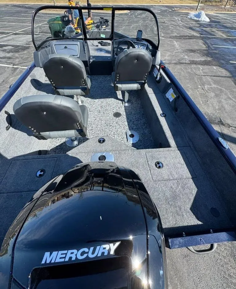Slide: The Image of 2025 Tracker Pro Guide V-16 WT boat with Mercury engine, featuring spacious seating and modern design. - 8