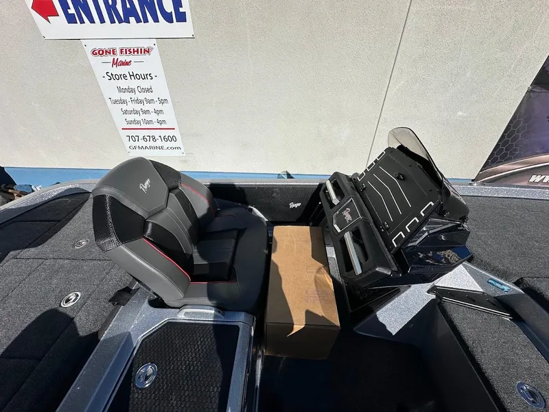 Slide: The Image of 2025 Ranger Z520 boat interior with seating and console, displayed at a fishing store entrance. - 14