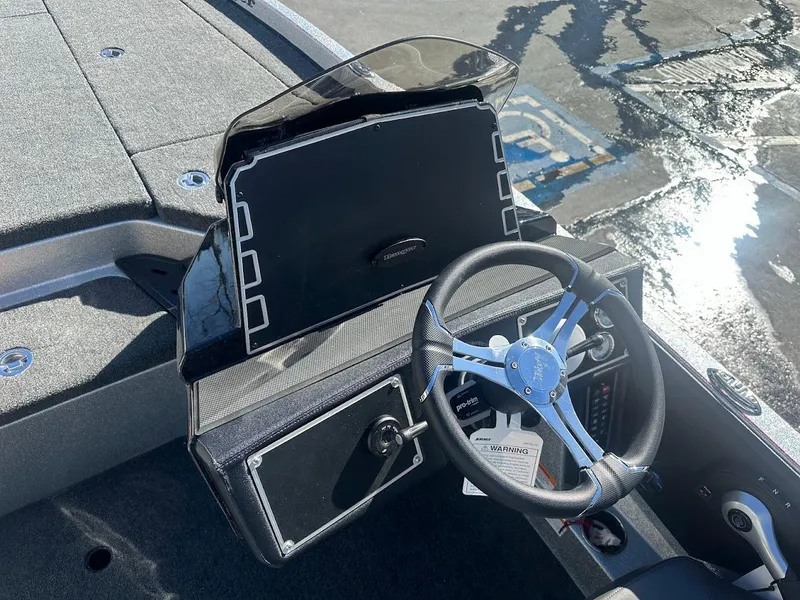 Slide: The Image of 2025 Ranger Z520 boat dashboard with steering wheel and control panel. - 19