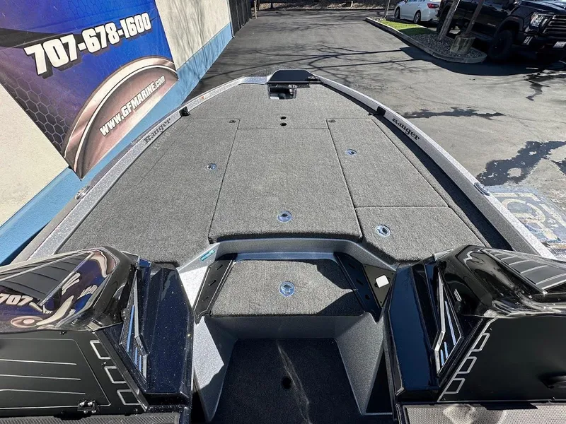 Slide: The Image of 2025 Ranger Z520 boat deck with storage compartments, parked outdoors. - 21