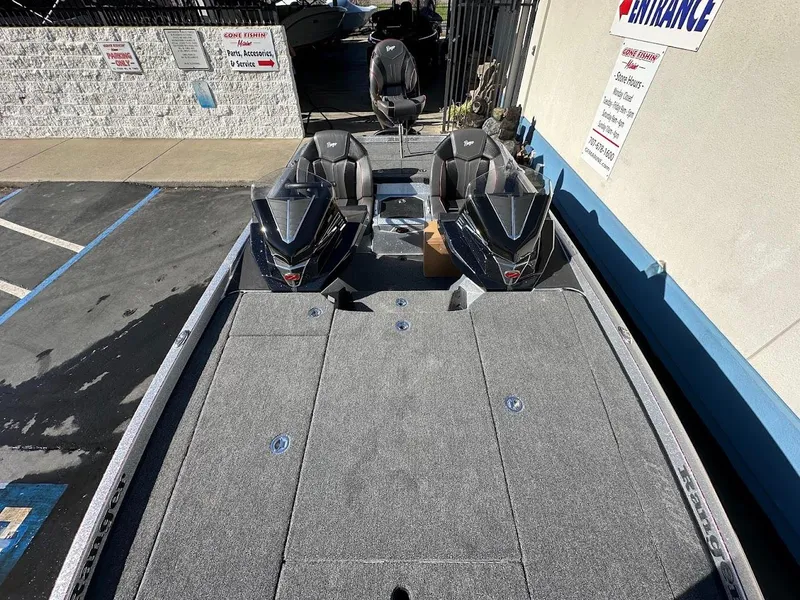 Slide: The Image of 2025 Ranger Z520 boat with dual seats and spacious deck, parked outdoors. - 23
