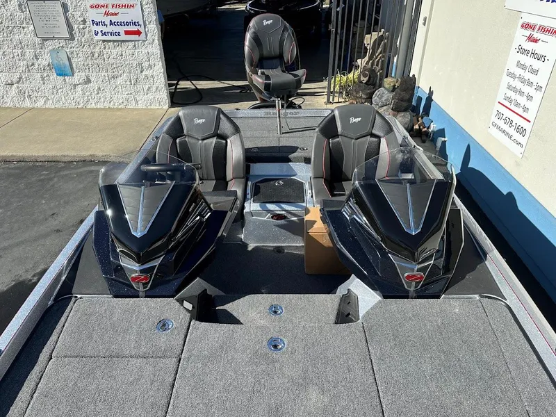 Slide: The Image of 2025 Ranger Z520 boat interior with dual seats and console, parked outside a service shop. - 24