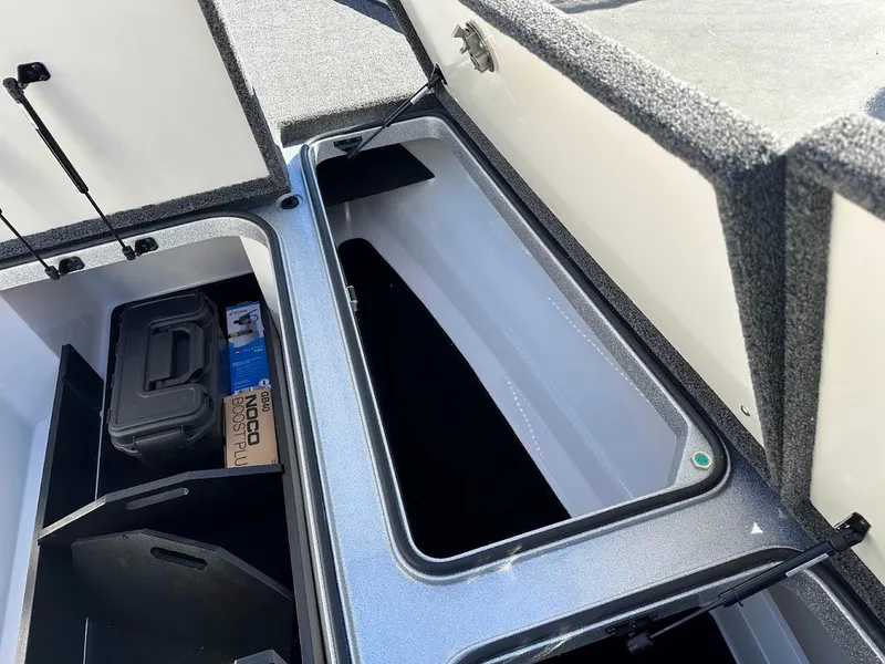 Slide: The Image of 2025 Ranger Z520 storage compartments with open lids, showcasing organized interior space. - 28