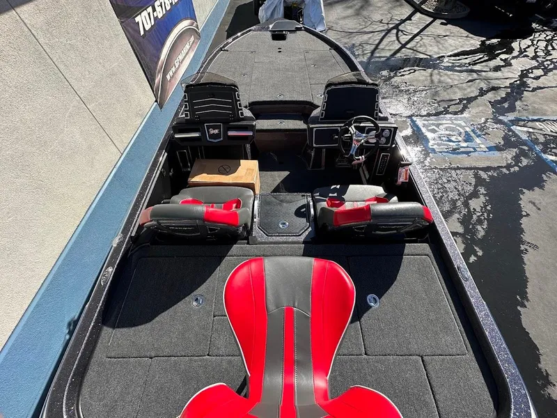 Slide: The Image of 2025 Ranger Z521 boat interior with foot pedal and warning labels. - 11
