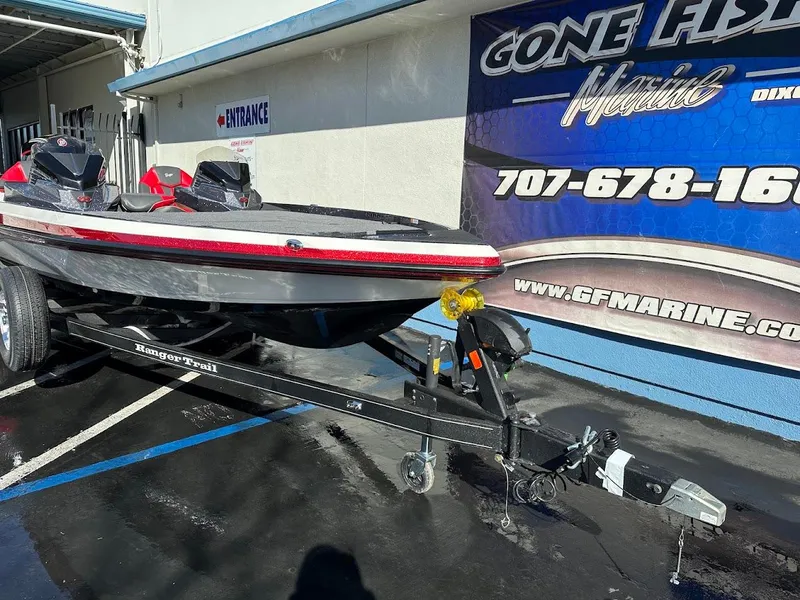 Slide: The Image of 2025 Ranger Z521 boat trailer hitch with winch and safety chains in parking lot. - 4