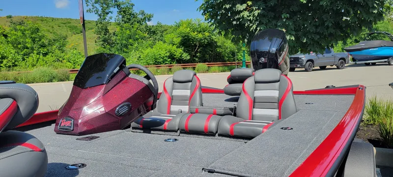 Slide: The Image of 2025 Ranger RT178C boat with sleek design, red accents, and comfortable seating in a scenic outdoor setting. - 3