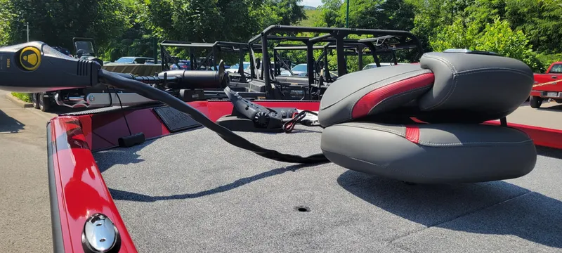 Slide: The Image of 2025 Ranger RT178C boat with red and gray seating, parked outdoors. - 4