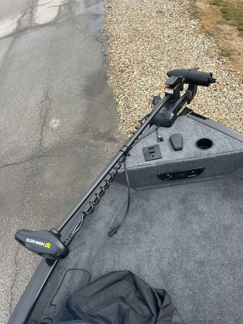 Slide: The Image of 2025 Tracker Pro Guide V-175 Combo boat with trolling motor on a gravel path. - 11