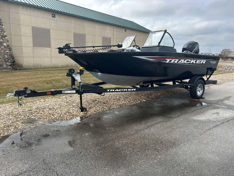 Slide: The Image of 2025 Tracker Pro Guide V-175 Combo boat on trailer, parked outdoors. - 3