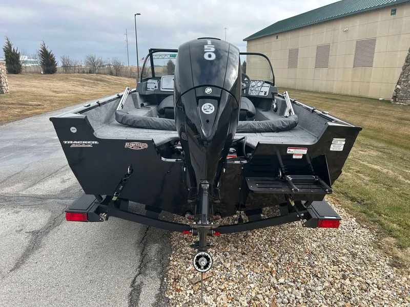 Slide: The Image of 2025 Tracker Pro Guide V-175 Combo boat with powerful outboard motor, parked on a driveway. - 5