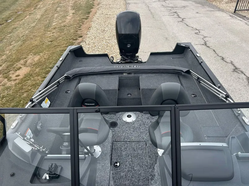 Slide: The Image of 2025 Tracker Pro Guide V-175 Combo boat interior with seating and motor, viewed from above. - 7