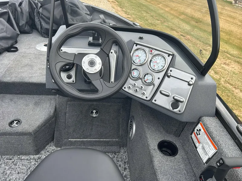 Slide: The Image of 2025 Tracker Pro Guide V-175 Combo boat dashboard with steering wheel and gauges. - 8