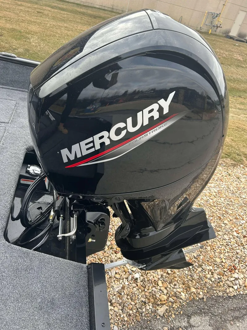 Slide: The Image of 2025 Tracker Pro Guide V-175 Combo with Mercury outboard motor, parked on gravel. - 9