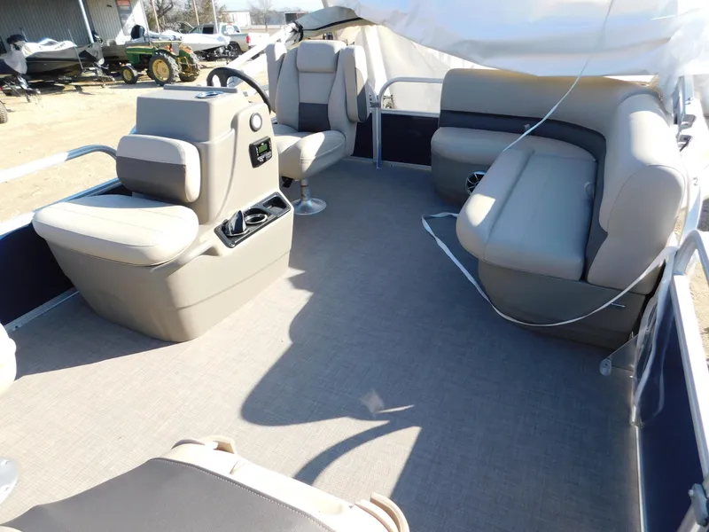 Slide: The Image of 2025 Sun Tracker Bass Buggy 16 XL Select pontoon boat interior with seating and helm. - 15