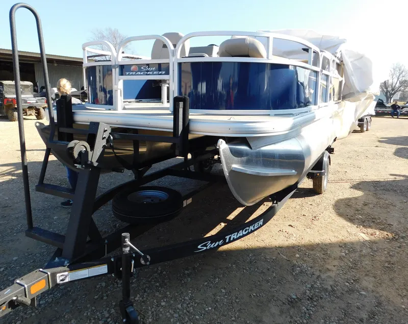 Slide: The Image of 2025 Sun Tracker Bass Buggy 16 XL Select pontoon boat on trailer. - 18