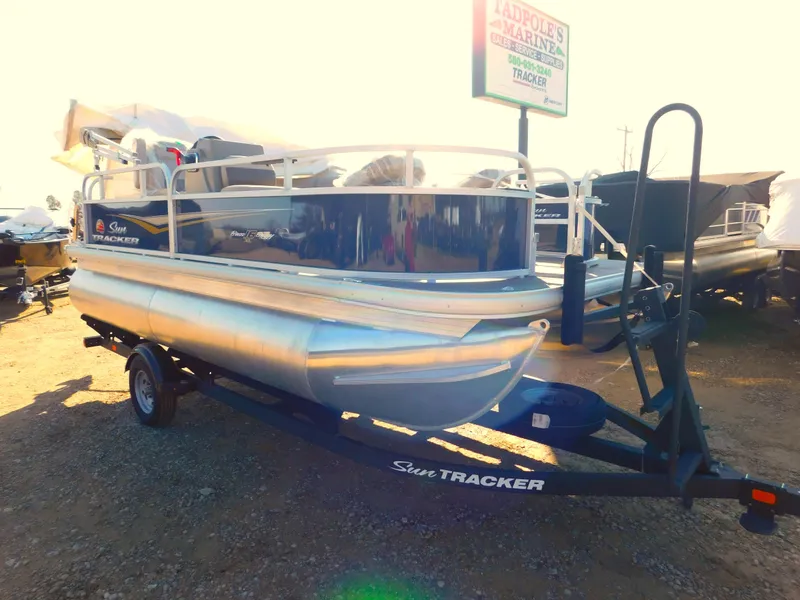 Slide: The Image of 2025 Sun Tracker Bass Buggy 16 XL Select pontoon boat on trailer. - 3