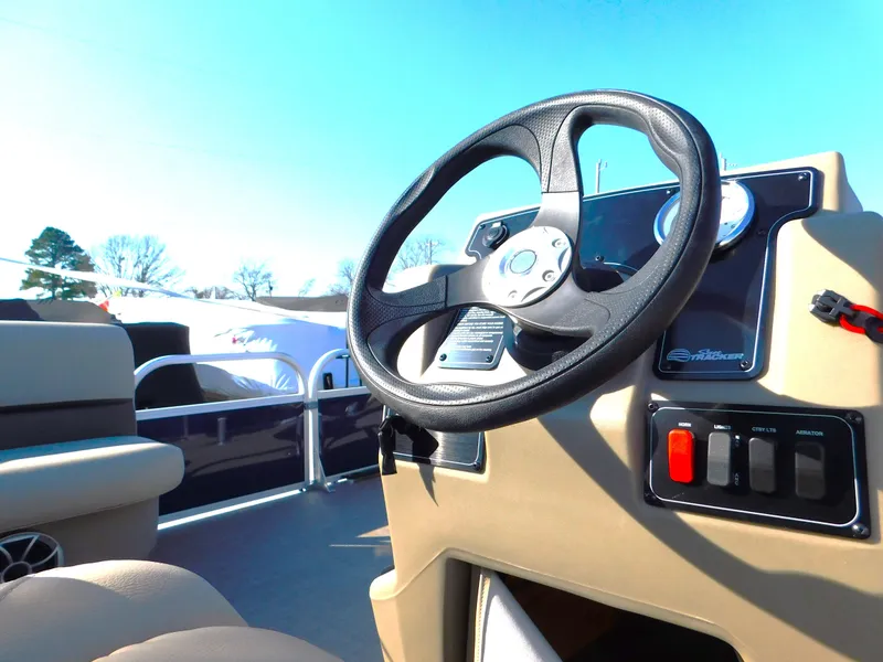 Slide: The Image of 2025 Sun Tracker Bass Buggy 16 XL Select steering console, featuring modern controls and comfortable seating. - 8