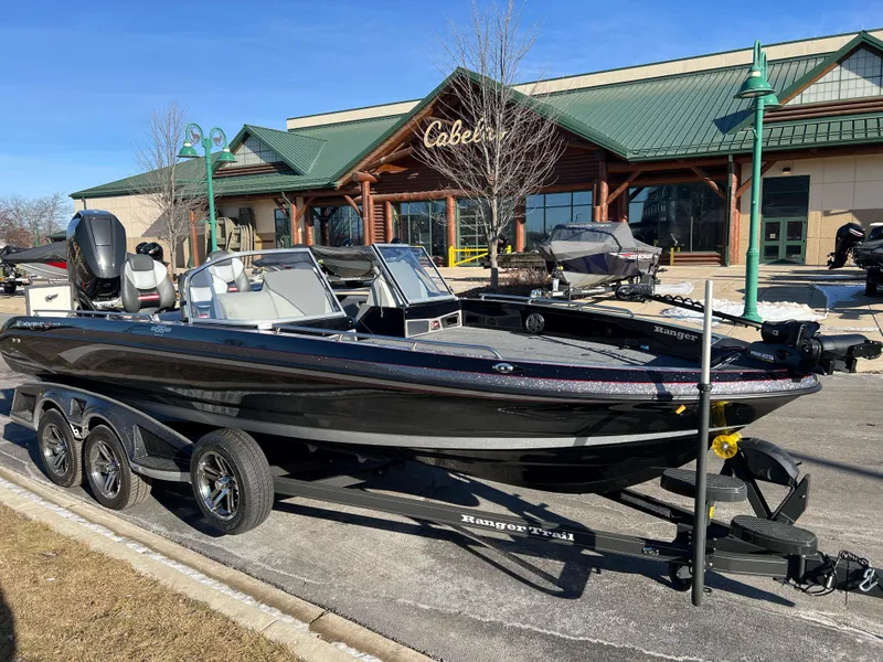 Slide: The Image of 2024 Ranger 622FS Pro boat on trailer outside Cabela's store. - 2