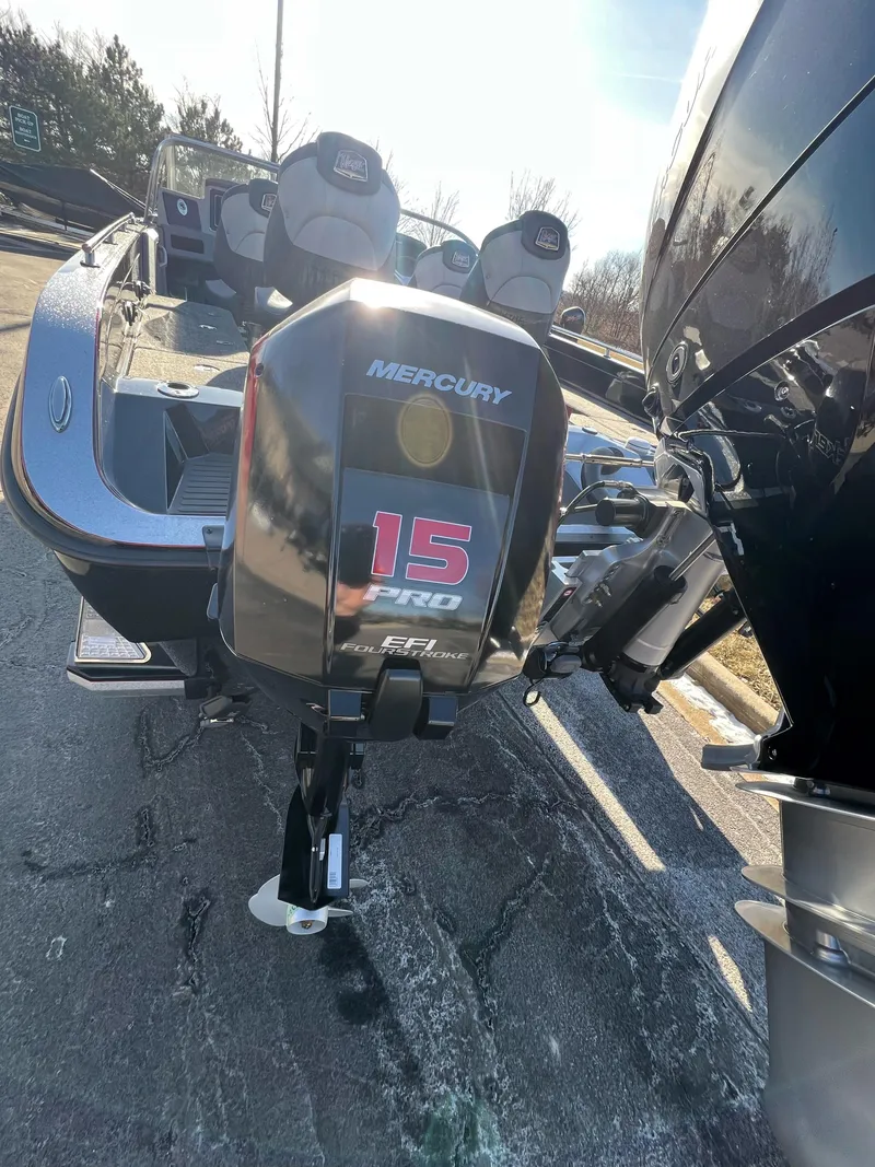 Slide: The Image of 2024 Ranger 622FS Pro boat with Mercury 15 Pro outboard motor, parked outdoors. - 4