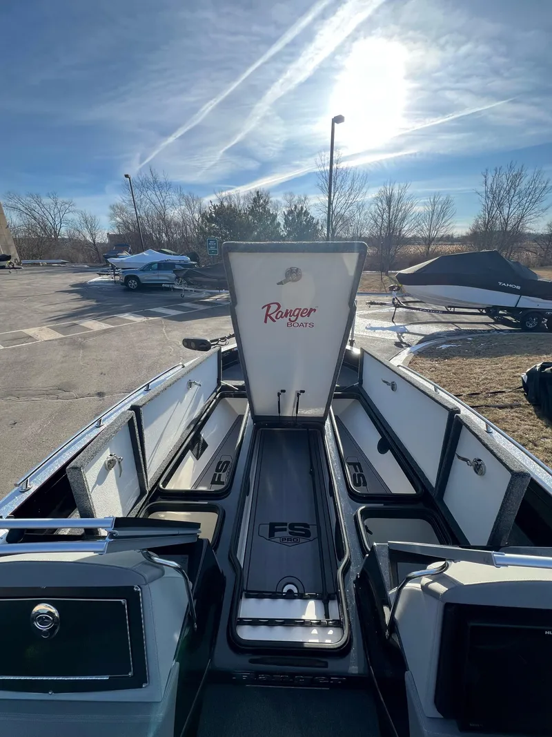 Slide: The Image of 2024 Ranger 622FS Pro boat interior with open storage compartments under a bright sky. - 7